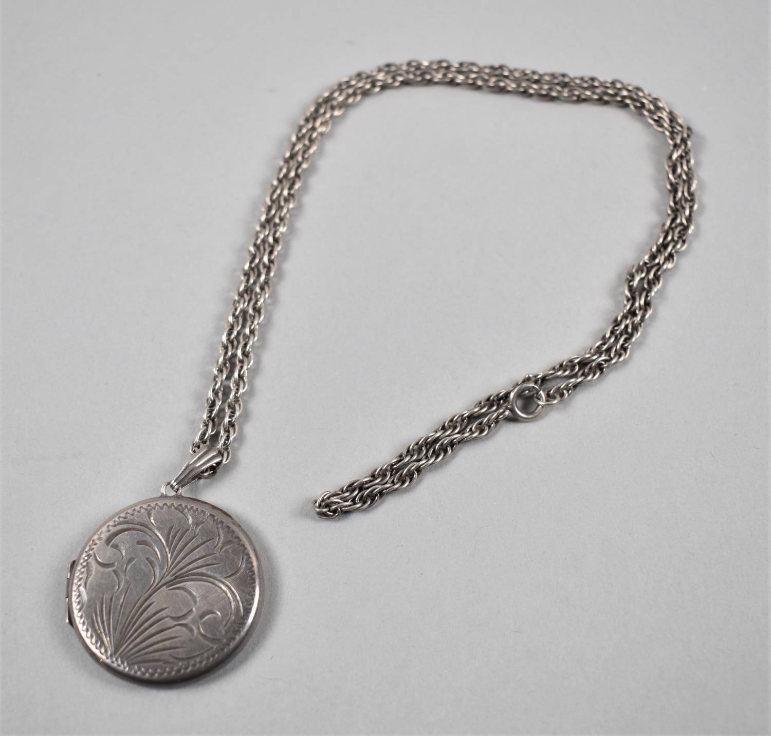 A Circular Silver Photo Locket on Chain