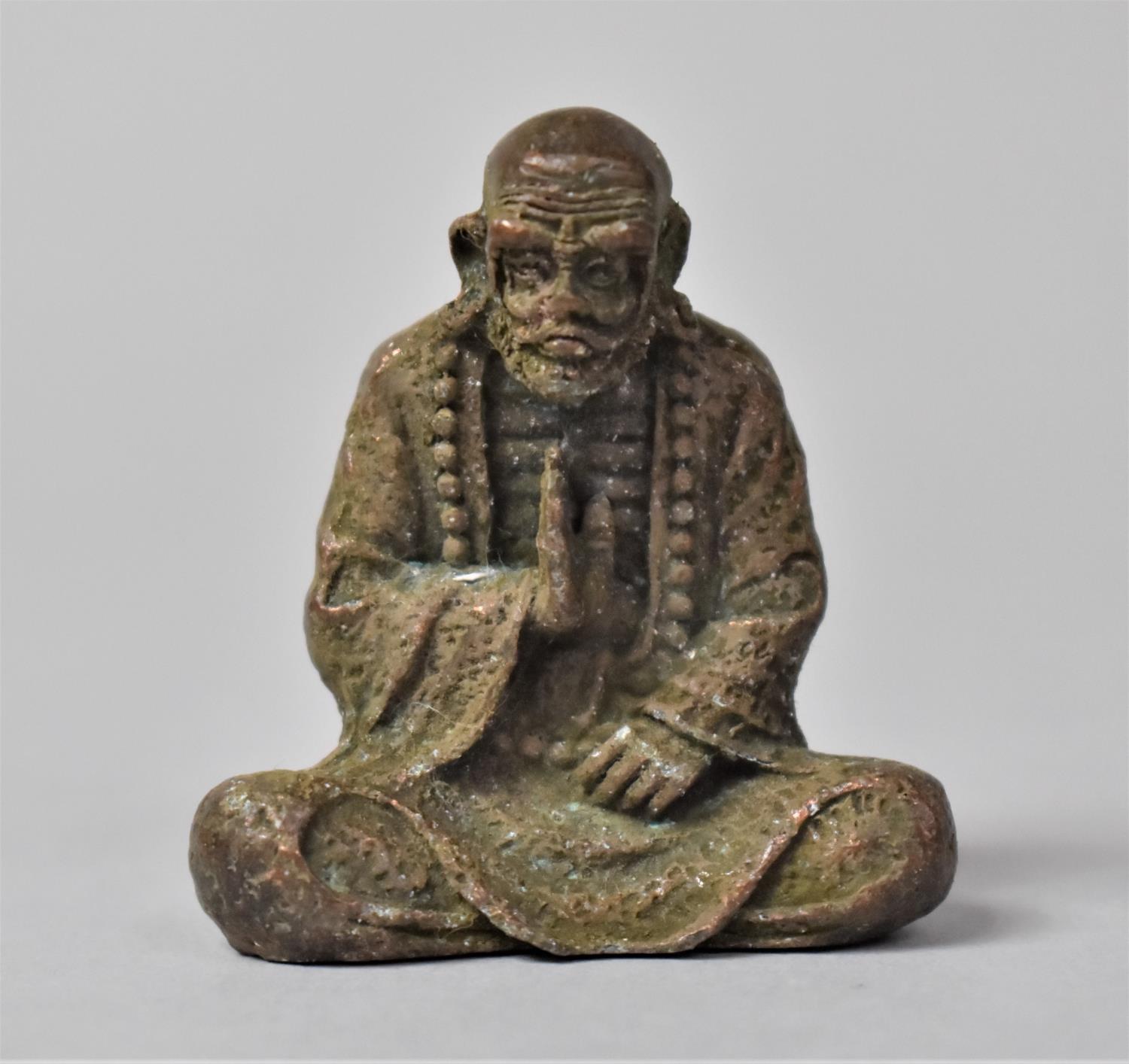 A Bronze Study of a Seated Monk, 4.5cm high