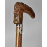 A 19th Century Walking Stick with a Carved Wooden Handle Modelled as a Bearded Man and an Eagles