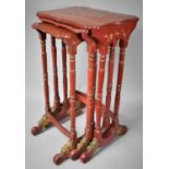 A Nest of Three Early 20th Century Chinese export red Lacquered Tables with Gilt Decoration