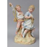 A Heubach German Porcelain Figure Group, Depicting Boy and Girl at play, Set on Naturalistic Base.