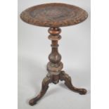 A Carved Victorian Walnut Circular Topped Tripod Table with Scrolled Feet. 42cms Diameter