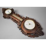 A Late Victorian Carved Oak Wheel Barometer, Clock and Thermometer. Foliate Decoration, 67cm High