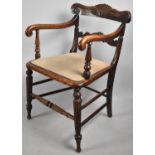 A 19th Century Oak Armchair with Carved and Scrolled Top Rail, Reeded Supports and Stretchers.