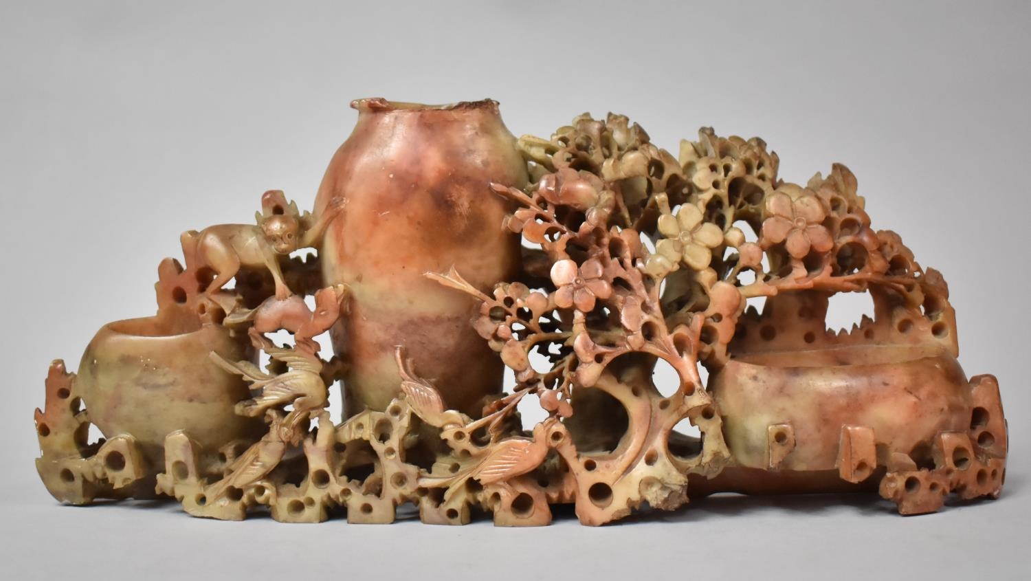 A Late 19th Century Chinese Carved Soapstone Group of Three Brush Pots Surrounded by Foliage and