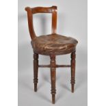 A 19th Century Circular Seated Bar Back Music or Harpist Chair on Turned Supports with Buttoned Hide