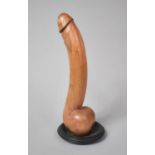 An Indonesian Carved Wooden Phallus Mounted on a Back Slate Plinth, 32cm high