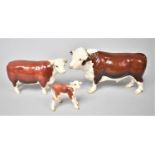 A Beswick Polled Hereford Bull together with a Cow and Calf