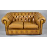 A Tan Leather Chesterfield Two Seater Settee with Buttoned Upholstery, 144cm wide