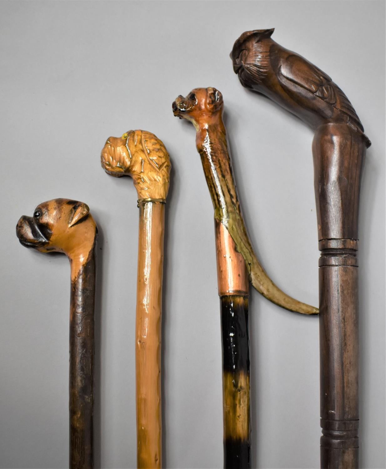 A Group of Four 20th Century Walking Sticks and Canes with Carved Animal Head Handles, The Longest