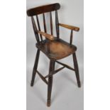 A 19th Century Child's High Chair with a Spindled Back Over a Shaped Elm Seat Supported on Long