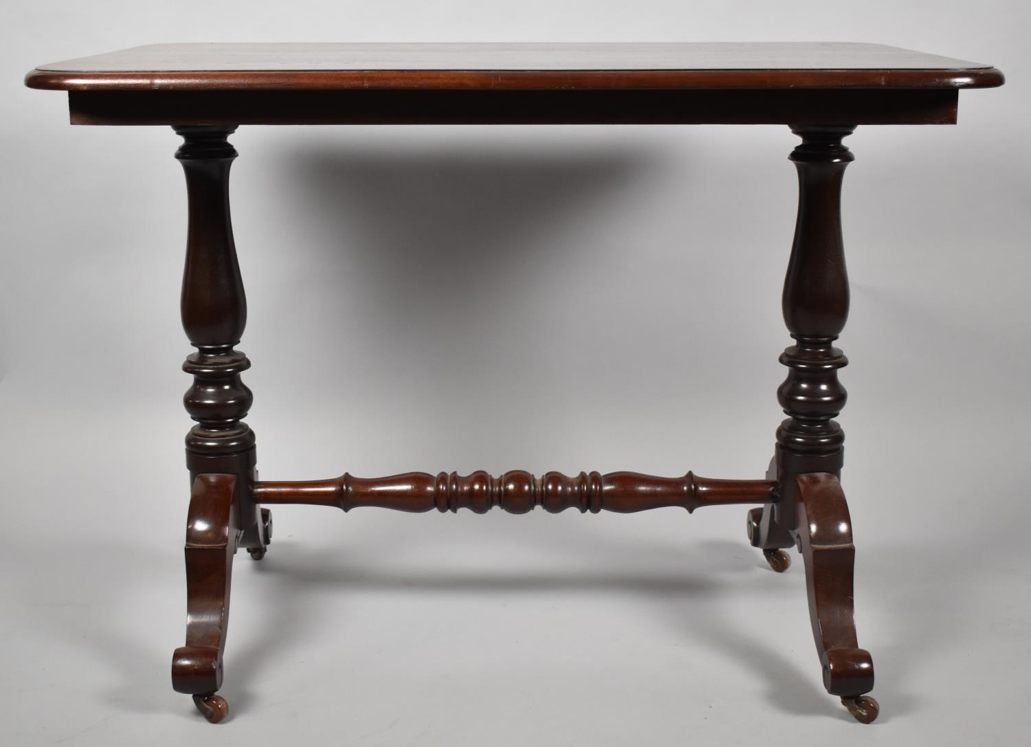 A Victorian Mahogany Rectangular Centre Table with turned Supports and Scrolled Feet. 107x66x79