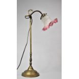 An Edwardian Brass Adjustable Reading Lamp with Cranberry Fringed Opaque Glass Shade, 55cms High