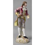 A Continental Porcelain Figure of Dandy with Floral Waistcoat and Frock Coat. 33cms High