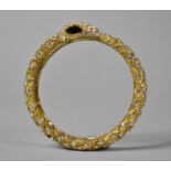 A Heavy Gilt Metal Bangle in the Form of a Snake
