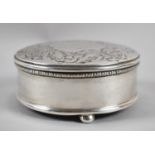 A Silver Circular Dressing Table Jewellery Box on Three Bun Feet, Repousse Work Decoration to Hinged