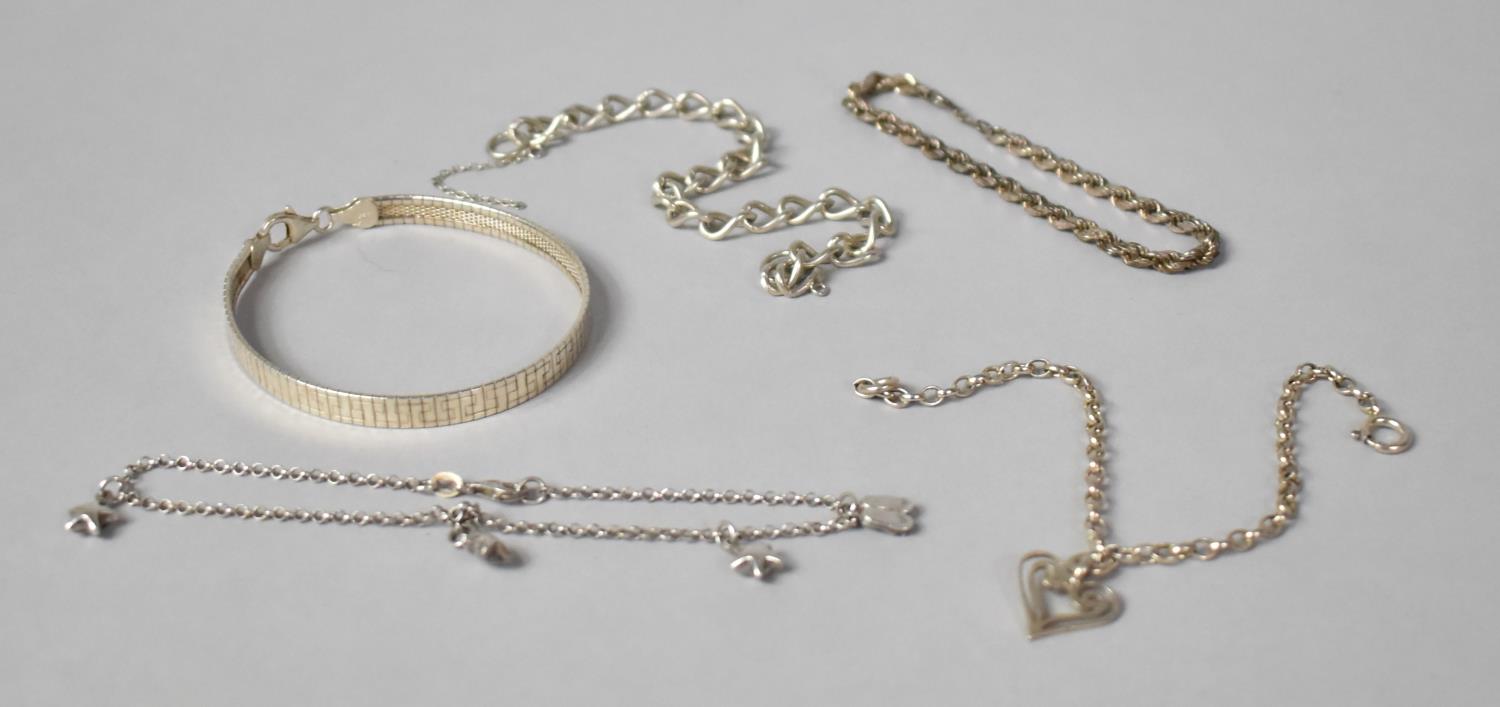 A Silver Bangle, Three Silver Bracelets and Small Charm Bracelet, One requires attention