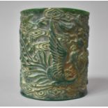 A Heavy Chinese Jadeite Brush Pot Decorated in Relief with Dragons Chasing the Flaming Pearl, 15cm
