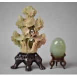 A Carved Soapstone Item on Stand Together with a Jadeite Egg on Stand