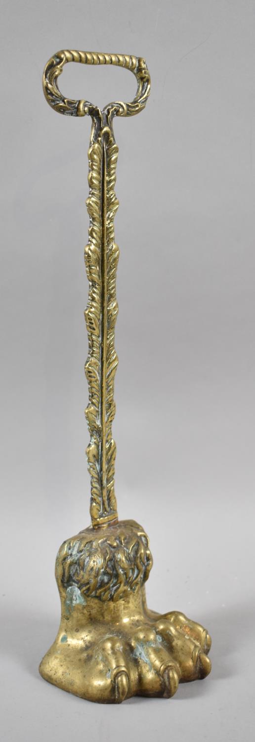 A 19th Century Brass Door Porter in the Form of a Lion's Paw, 38cm high