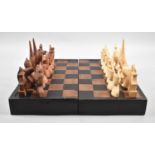 A Carved Wooden Indonesian Chess Set on Edwardian Folding Wooden Chessboard, 33cm Square