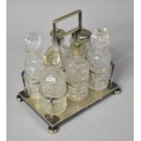 An Edwardian Silver Plated and Glass Six Bottle Cruet on Four Bun Feet, 18cm wide
