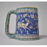 An Iznik Pottery Tankard Decorated with Deer and Flowers, 13.5cm high