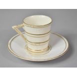 A Royal Worcester Aesthetic Cream and Gilt Coffee Can and Saucer