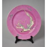 A Mid/Late 20th Century Japanese Plate with Applied Enamels Depicting Dragon on Pink Ground Produced