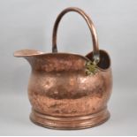 A Mid 20th Century Copper Helmet Shaped Coal Scuttle