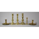 A Collection of Brass Candlesticks and Chamber Sticks