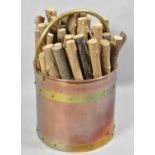 A Cylindrical Copper and Brass Coal Bucket Containing Kindling, 29cm high