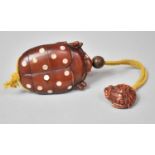 A Japanese Novelty Wooden Inro in the Form of a Bug with Inset Mother of Pearl Disk Decoration,