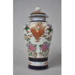 A Chinese Export Baluster Vase and Cover Decorated with Applied Enamels on a Floral Motif with