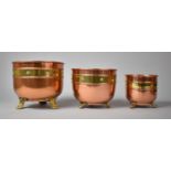 A Set of Three Graduated Copper and Brass Circular Planters on Claw Feet, the Largest 21cm