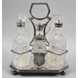 An Edwardian Silver Plate Mounted Glass Six Bottle Cruet Set on Four Ball Feet, 25cm high
