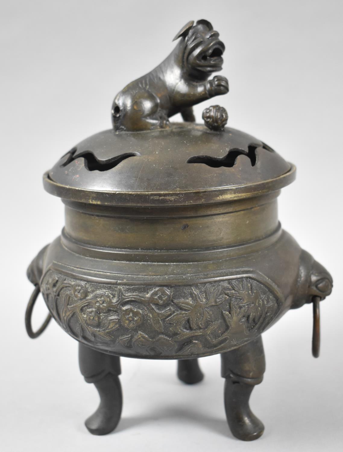 A Bronze Incense Burner Supported on Tri Supports the Body Having Twin Ring Handles with Temple Lion