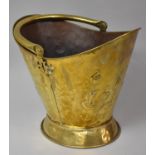 A Brass Helmet Shaped Coal Scuttle with Pressed Art Nouveau Floral Decoration, 33cm High