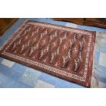 A Good Quality Patterned Woollen Rug on Red Ground with Long Fringing, 200cm x 135cm