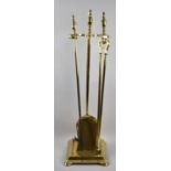 A Good Quality Brass Fire Companion Set with Long Handled Fire Irons on Square Base and Bun Feet,