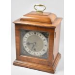 A Good Quality Walnut Cased Mantle Clock with Domed Top and Brass Carrying Handle, with Key and