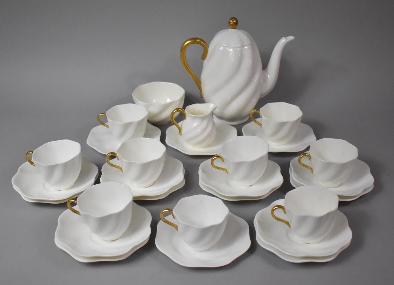 A Coalport White and Gilt Decorated Tea Set to comprise Nine Cups, Six Saucers, Ten Side Plates, Tea