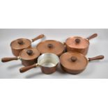 A Collection of Six Copper Cooking Pans with Turned Wooden Handles,
