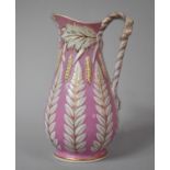 A Late 19th Century Glazed Staffordshire Jug in Pink Enamels Body Decorated in Relief, 22cm high