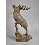 A Large Carved American Wooden Study of a Stag on Rock, 56cm high