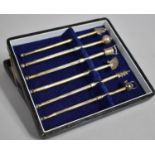 A Cased Set of Six Novelty Cocktail Swizzle Sticks with Oriental Themed Finials to Include Buddha,