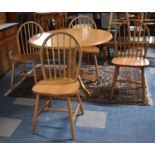 A Modern Circular Kitchen Dining Table and Four Spindle Back Chairs