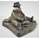 A Victorian Novelty Cast Iron Inkwell in the form of Seated Portly Gentleman Wearing Tails About