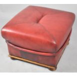 A Modern Leather Effect Oxblood Footstool, 56cm