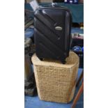 A Wicker Linen Basket and Wheeled Suitcase